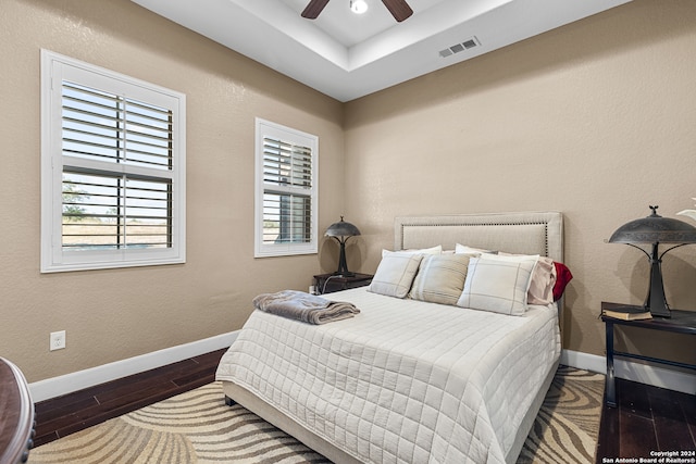 bedroom with dark hardwood / wood-style floors and ceiling fan