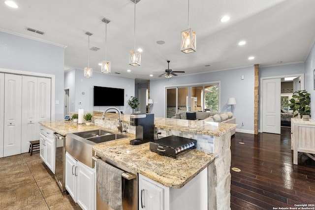 kitchen featuring white cabinetry, a large island with sink, decorative light fixtures, and dark hardwood / wood-style flooring