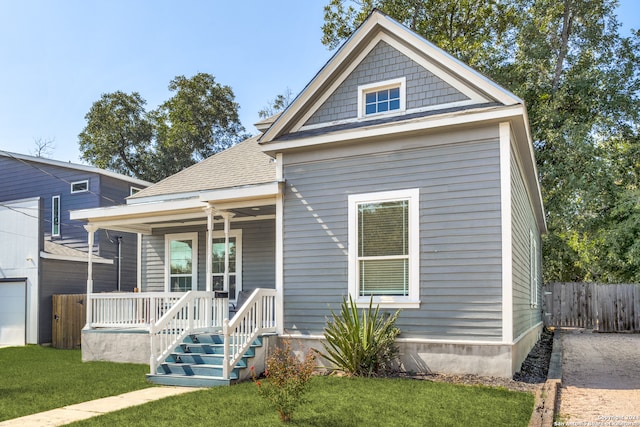 view of front facade with a front yard and a porch