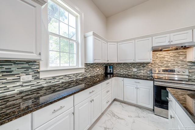 kitchen with electric range, dark stone counters, and white cabinets