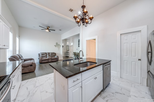 kitchen featuring sink, stainless steel appliances, white cabinets, dark stone countertops, and a kitchen island with sink