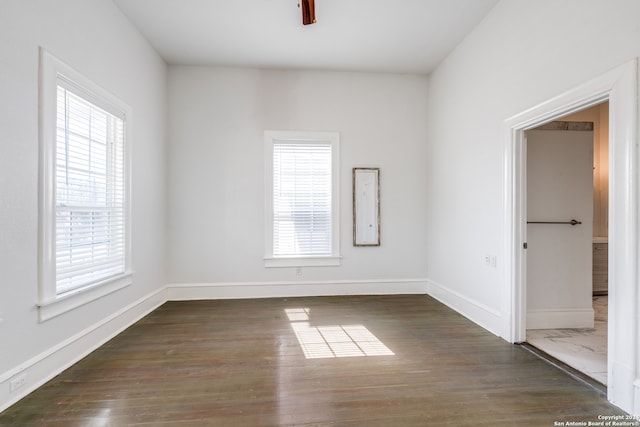 unfurnished room with dark hardwood / wood-style floors