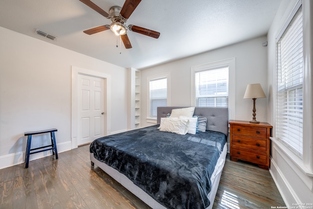 bedroom with dark wood-type flooring and ceiling fan