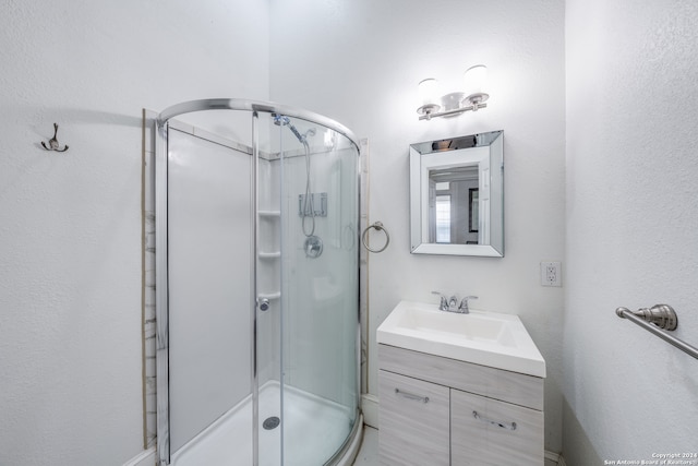 bathroom with vanity and a shower with shower door