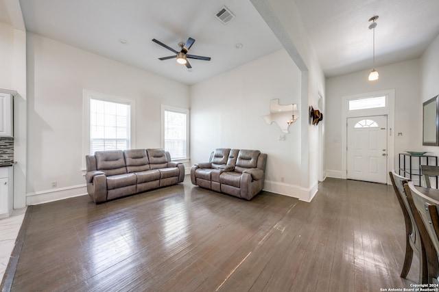 living room featuring ceiling fan and dark hardwood / wood-style flooring