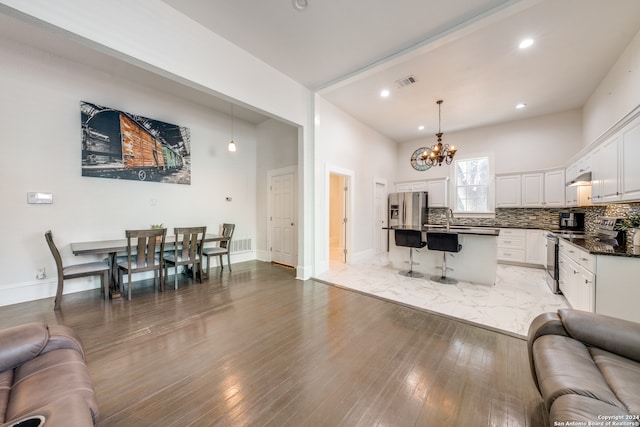 living room featuring light hardwood / wood-style floors, sink, and a chandelier