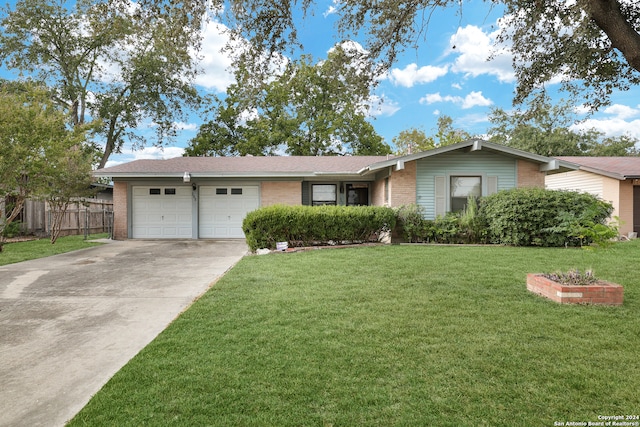 single story home featuring a front yard and a garage