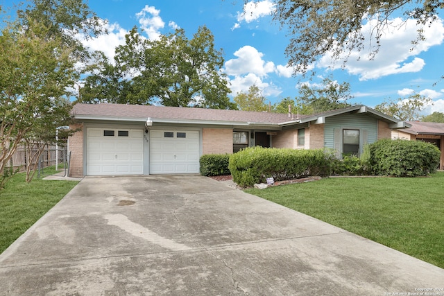 single story home featuring a front lawn and a garage