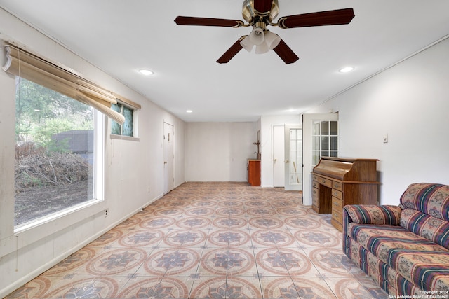 tiled living room featuring ceiling fan