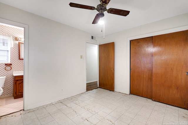 unfurnished bedroom with connected bathroom, a closet, and ceiling fan