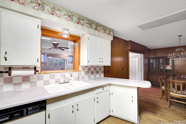 kitchen featuring decorative backsplash, white cabinets, white dishwasher, light wood-type flooring, and sink