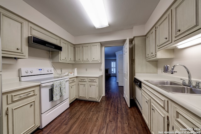 kitchen with white appliances, sink, cream cabinetry, dark hardwood / wood-style flooring, and extractor fan