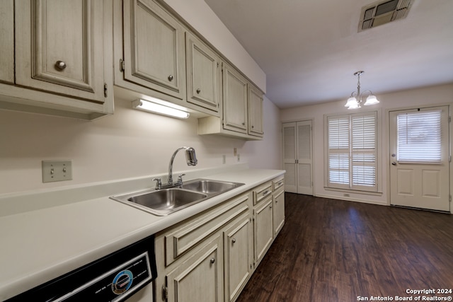 kitchen with cream cabinets, dishwashing machine, a chandelier, dark hardwood / wood-style floors, and sink