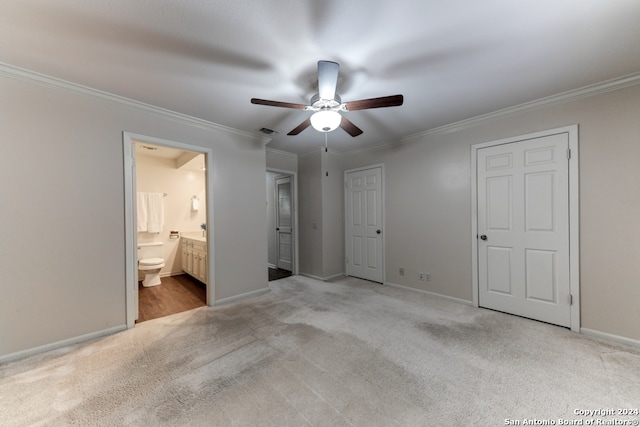 unfurnished bedroom with crown molding, light carpet, ensuite bathroom, and ceiling fan