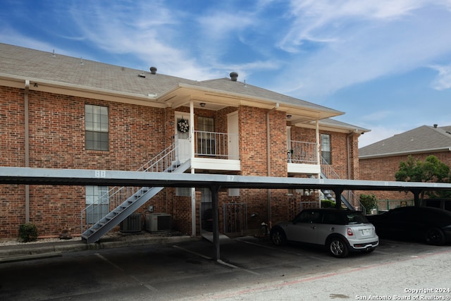 exterior space with a carport and cooling unit