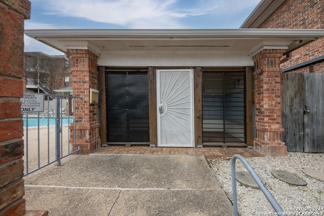 entrance to property featuring a community pool