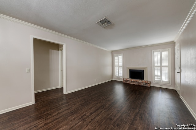 unfurnished living room featuring ornamental molding, dark hardwood / wood-style floors, a textured ceiling, and a fireplace