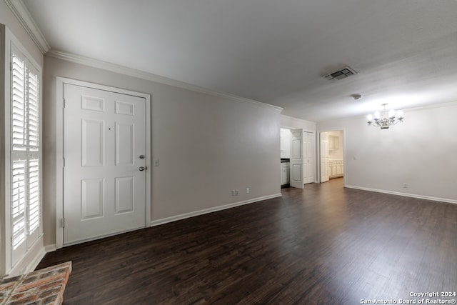 interior space featuring a notable chandelier, ornamental molding, and dark hardwood / wood-style flooring