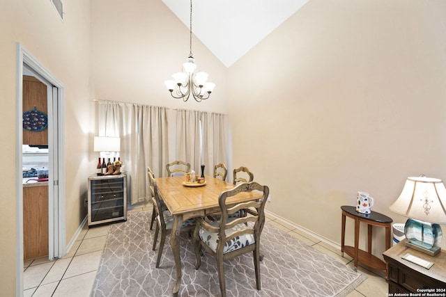 tiled dining space featuring a notable chandelier and high vaulted ceiling