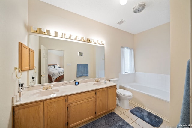 bathroom featuring a textured ceiling, toilet, vanity, a tub to relax in, and tile patterned floors