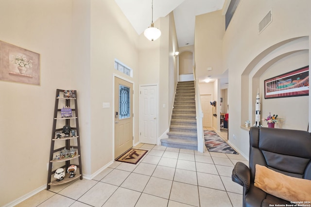 tiled foyer with high vaulted ceiling