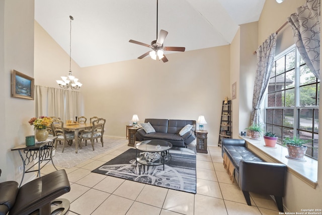 tiled living room featuring ceiling fan with notable chandelier and high vaulted ceiling