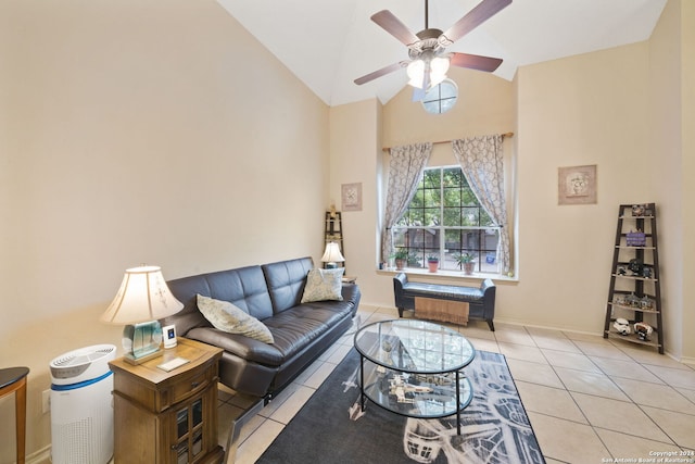 tiled living room with ceiling fan and high vaulted ceiling