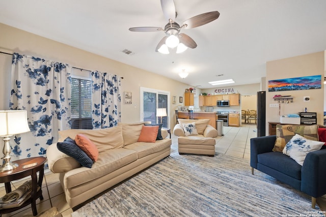 tiled living room featuring ceiling fan