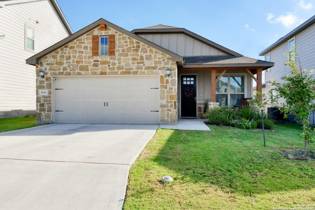 view of front of property with a front lawn and a garage