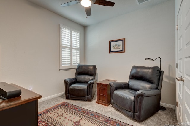 living area with light carpet and ceiling fan