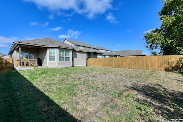 rear view of property with a lawn