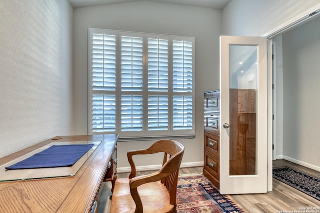 office space with hardwood / wood-style flooring and lofted ceiling