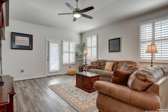 living room featuring light hardwood / wood-style floors and ceiling fan