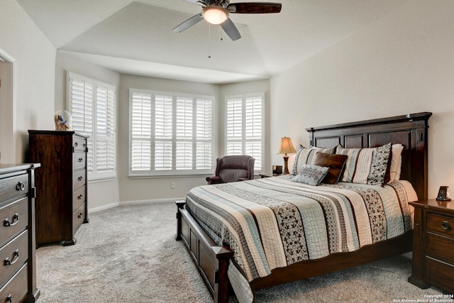 carpeted bedroom featuring ceiling fan and vaulted ceiling