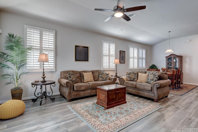 living room featuring ceiling fan, lofted ceiling, and light hardwood / wood-style flooring