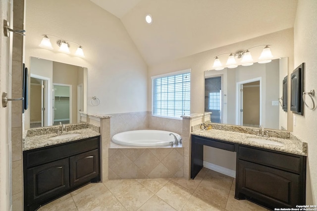 bathroom featuring vanity, lofted ceiling, tile patterned flooring, and tiled tub