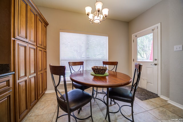 tiled dining room featuring a chandelier