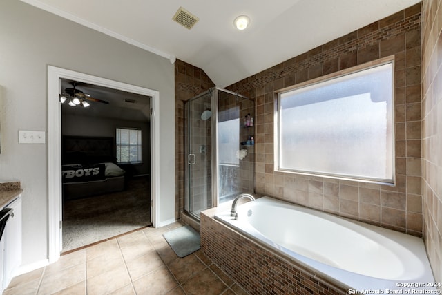 bathroom featuring vanity, lofted ceiling, separate shower and tub, and tile patterned flooring