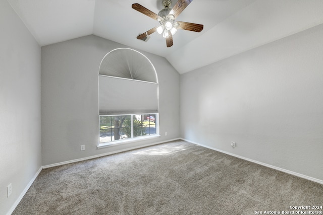 carpeted empty room with lofted ceiling and ceiling fan