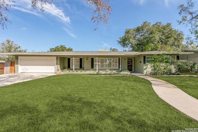 single story home featuring a garage and a front lawn