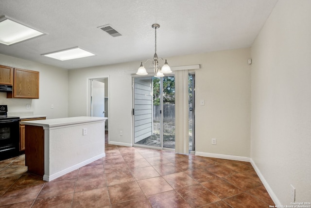 kitchen with a center island, pendant lighting, black / electric stove, a notable chandelier, and extractor fan