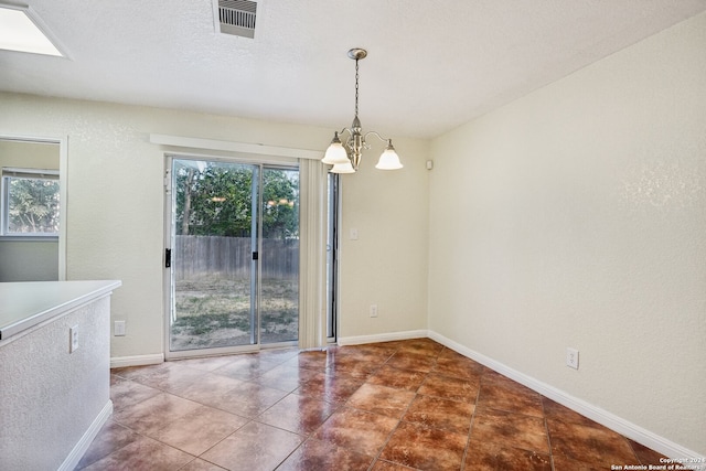 unfurnished dining area with a notable chandelier and a wealth of natural light