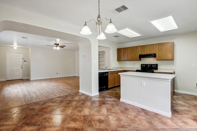 kitchen with black appliances, ceiling fan with notable chandelier, a center island, decorative light fixtures, and dark hardwood / wood-style floors