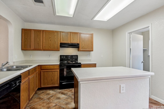 kitchen featuring exhaust hood, light tile patterned floors, black appliances, sink, and a center island