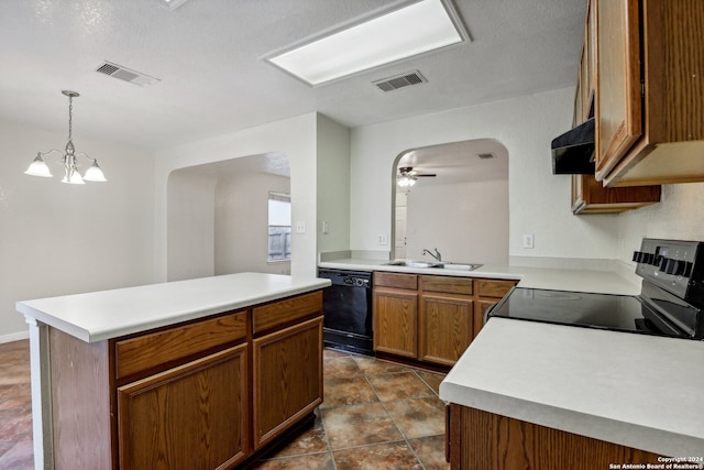 kitchen featuring hanging light fixtures, a kitchen island, black appliances, range hood, and sink