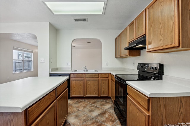 kitchen featuring tile patterned floors, black appliances, and sink