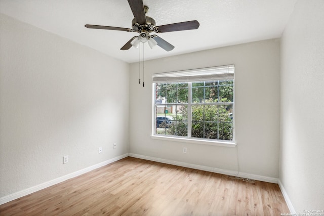 unfurnished room with light wood-type flooring and ceiling fan