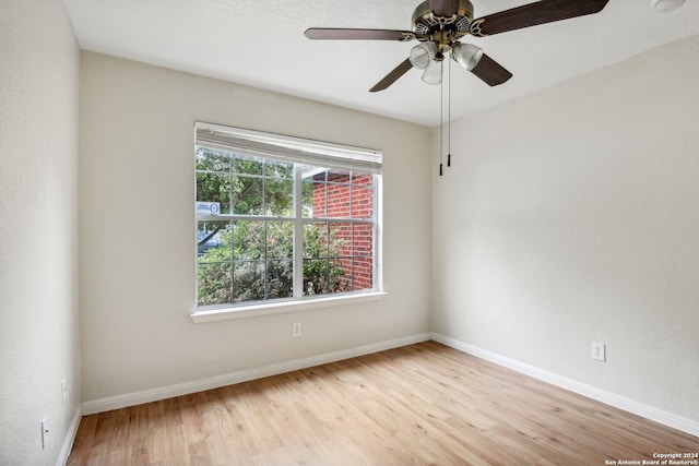 spare room featuring light hardwood / wood-style flooring and ceiling fan