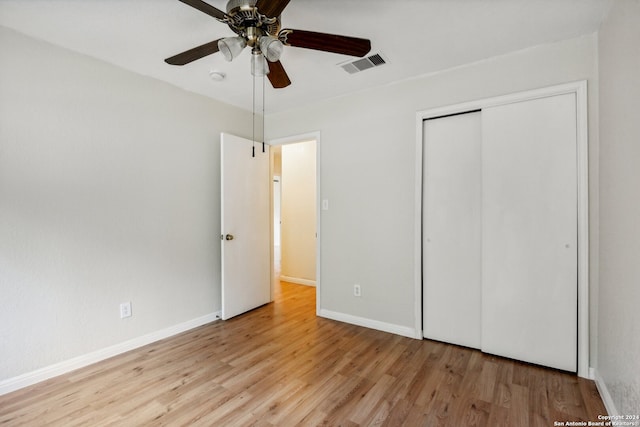 unfurnished bedroom featuring a closet, ceiling fan, and light wood-type flooring