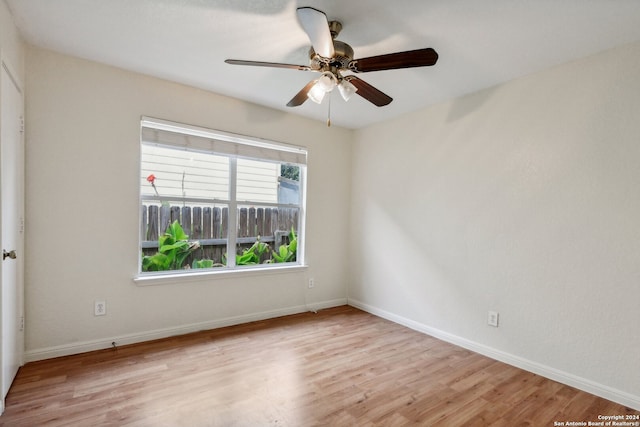 spare room featuring light hardwood / wood-style flooring and ceiling fan